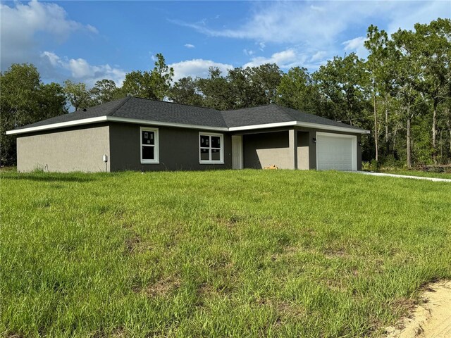 view of front of house with a garage and a front lawn