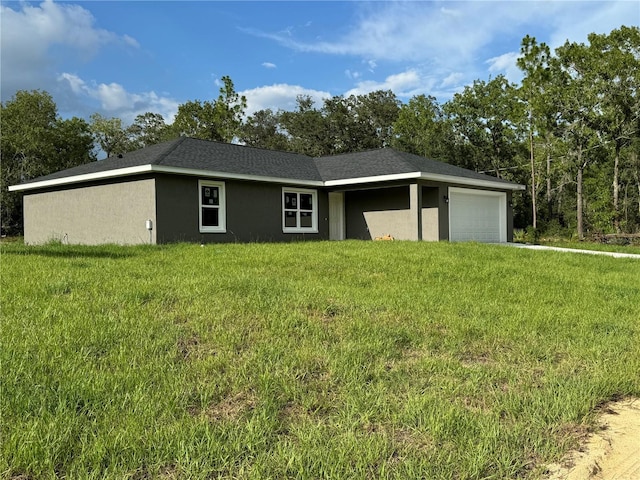 ranch-style home featuring a garage and a front yard