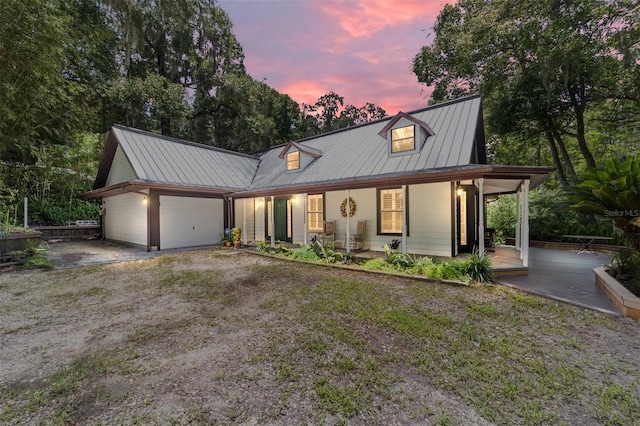 modern inspired farmhouse featuring a garage and covered porch