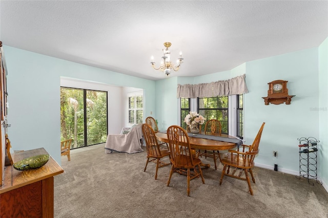 dining area featuring a textured ceiling, light carpet, and a chandelier