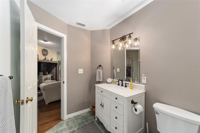 bathroom with tile patterned floors, vanity, and toilet