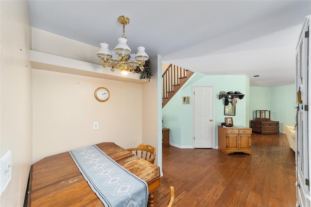 interior space featuring an inviting chandelier and dark hardwood / wood-style flooring