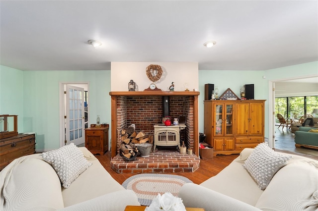 living room featuring a wood stove and hardwood / wood-style floors