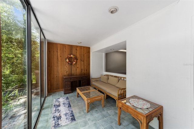 living room with floor to ceiling windows and wooden walls