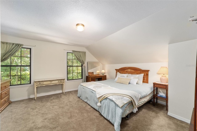 bedroom featuring carpet floors, multiple windows, and lofted ceiling