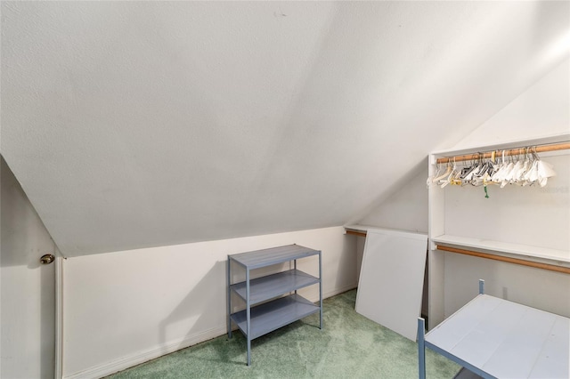 interior space featuring light carpet and vaulted ceiling