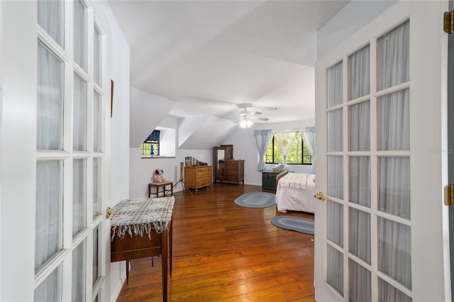 bedroom with hardwood / wood-style flooring, ceiling fan, lofted ceiling, and french doors