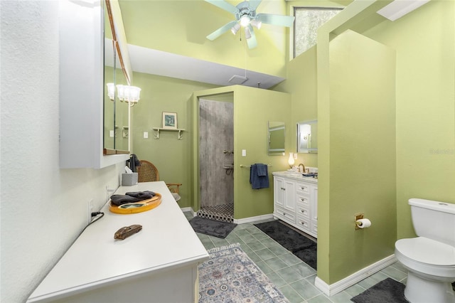 bathroom with toilet, ceiling fan, tile patterned floors, walk in shower, and vanity