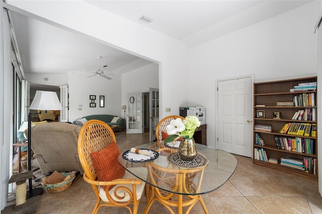 dining area featuring ceiling fan, light tile patterned floors, and lofted ceiling