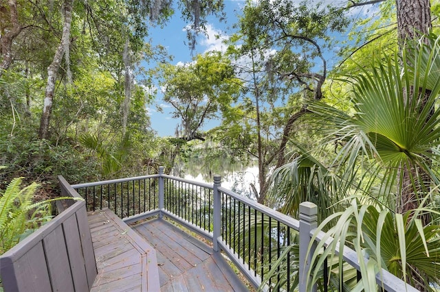 wooden terrace featuring a water view