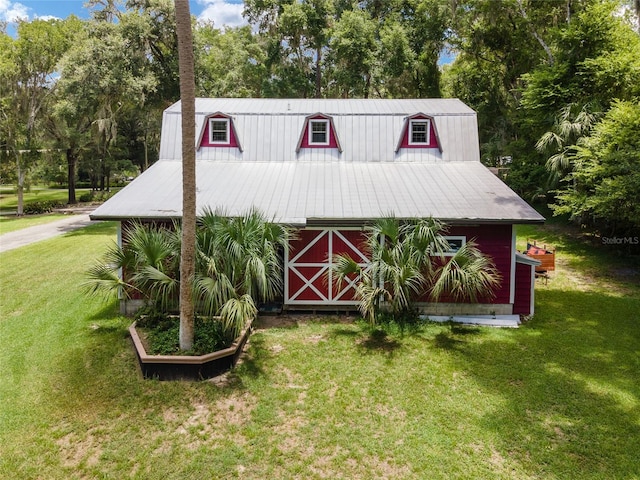 view of outbuilding featuring a yard