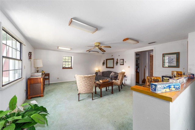 carpeted living room featuring ceiling fan