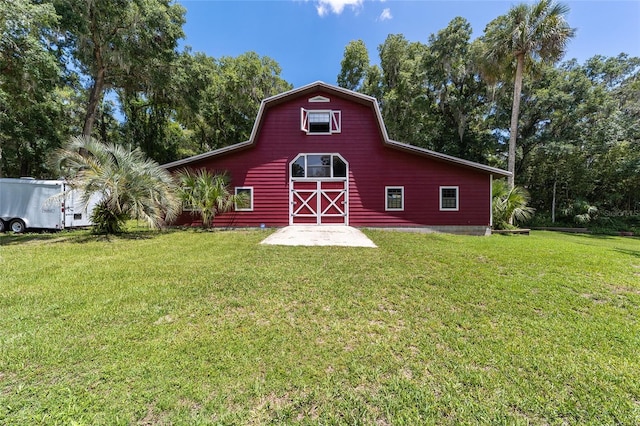 view of outbuilding featuring a lawn