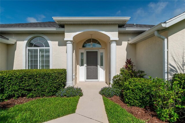 2260 NW 51st Ter, Ocala, FL 34482 - view of exterior entry featuring stucco siding and a shingled roof