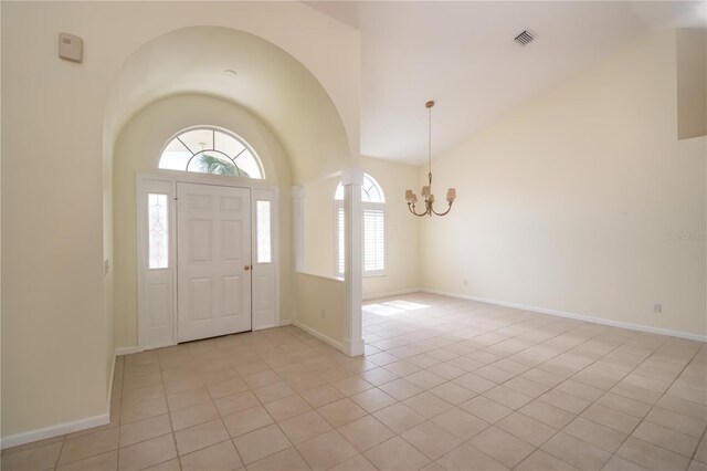2260 NW 51st Ter, Ocala, FL 34482 - entryway with a chandelier, light tile patterned floors, baseboards, and high vaulted ceiling