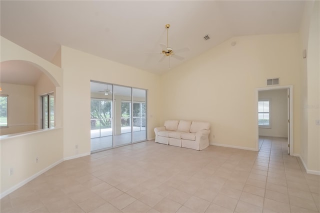2260 NW 51st Ter, Ocala, FL 34482 - unfurnished living room with ceiling fan, light tile patterned floors, arched walkways, high vaulted ceiling, and baseboards