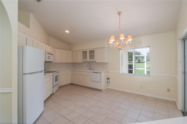 2260 NW 51st Ter, Ocala, FL 34482 - kitchen with white appliances, a chandelier, light countertops, light tile patterned floors, and vaulted ceiling