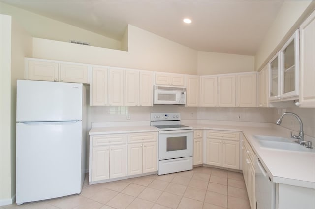 kitchen featuring light tile patterned flooring, sink, white appliances, and white cabinets