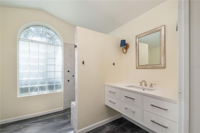 bathroom with vanity, tile patterned flooring, and lofted ceiling