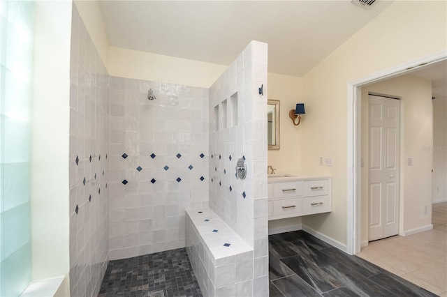 2260 NW 51st Ter, Ocala, FL 34482 - bathroom featuring tiled shower, vanity, and tile patterned flooring