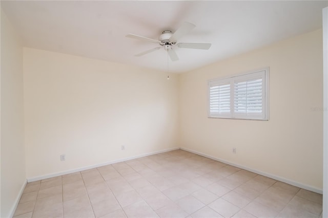 tiled spare room with ceiling fan