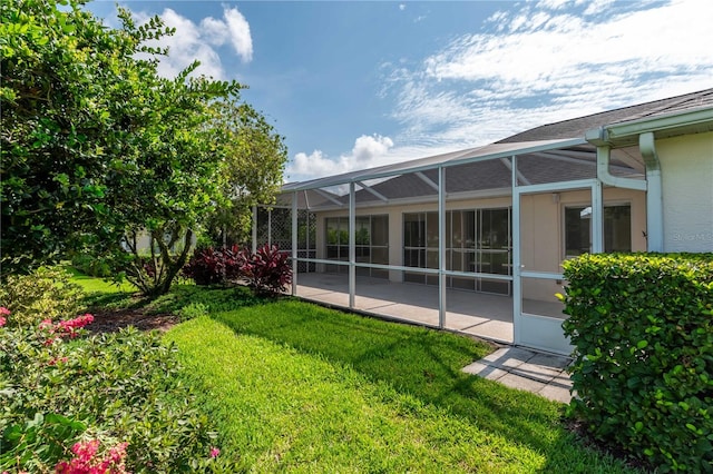 view of yard featuring a patio and a lanai