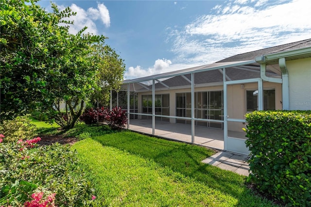 2260 NW 51st Ter, Ocala, FL 34482 - view of grassy yard featuring a patio area and glass enclosure