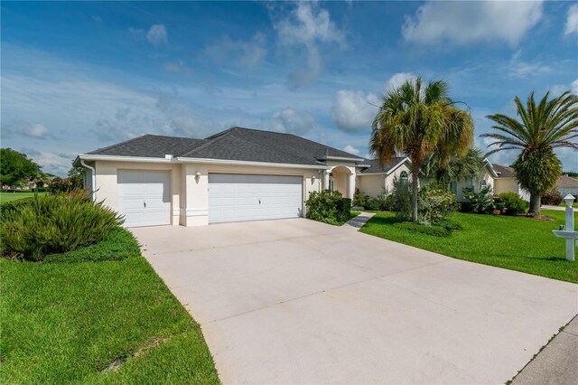 2260 NW 51st Ter, Ocala, FL 34482 - ranch-style house featuring a front yard, stucco siding, a garage, driveway, and roof with shingles