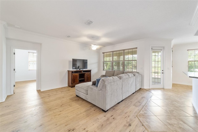 living room with crown molding, light hardwood / wood-style flooring, and ceiling fan