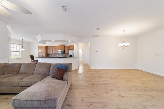 living room featuring ceiling fan with notable chandelier, ornamental molding, and light hardwood / wood-style floors