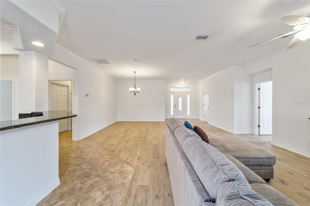 living room featuring crown molding, ceiling fan with notable chandelier, and light wood-type flooring