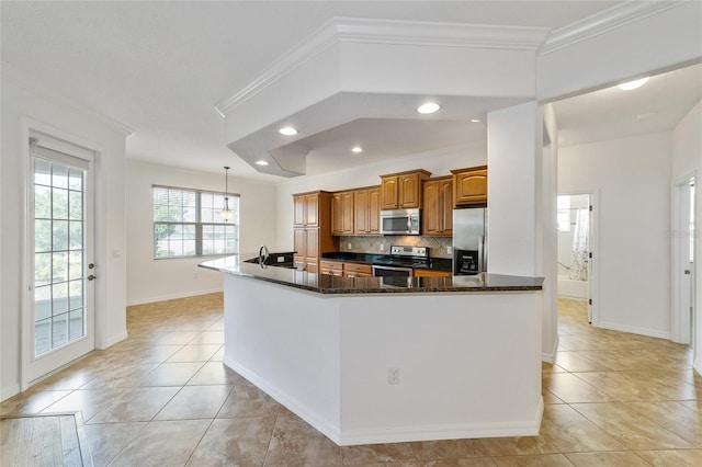 kitchen with light tile patterned flooring, crown molding, tasteful backsplash, dark stone countertops, and appliances with stainless steel finishes