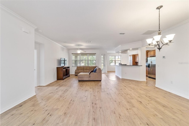 unfurnished living room featuring crown molding, ceiling fan with notable chandelier, and light hardwood / wood-style floors