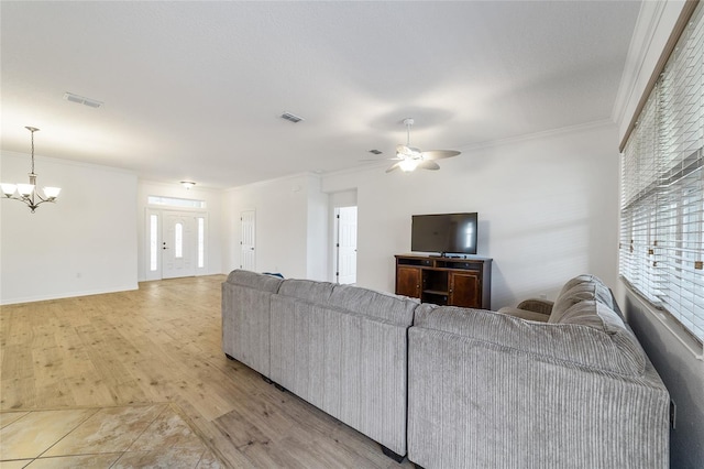 living room featuring ceiling fan with notable chandelier, ornamental molding, and light wood-type flooring