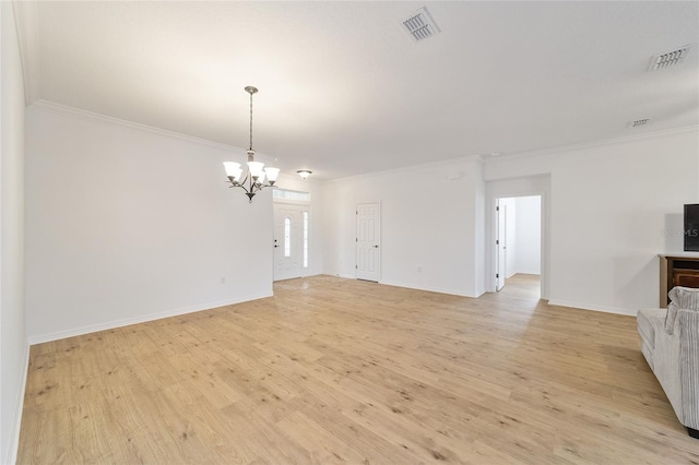 unfurnished living room with crown molding, an inviting chandelier, and light hardwood / wood-style floors