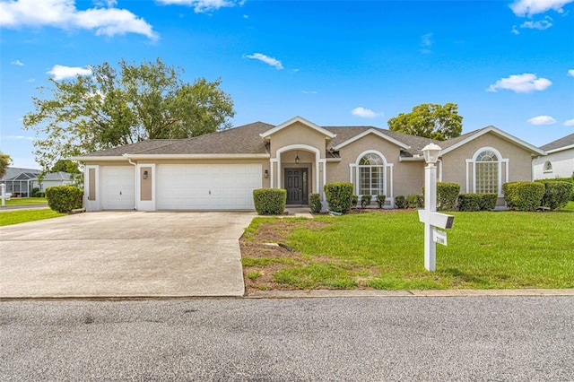 ranch-style home featuring a garage and a front lawn