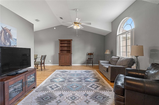 living room featuring vaulted ceiling, light hardwood / wood-style flooring, and ceiling fan