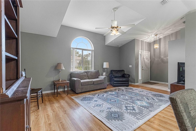 living room featuring light hardwood / wood-style flooring and ceiling fan