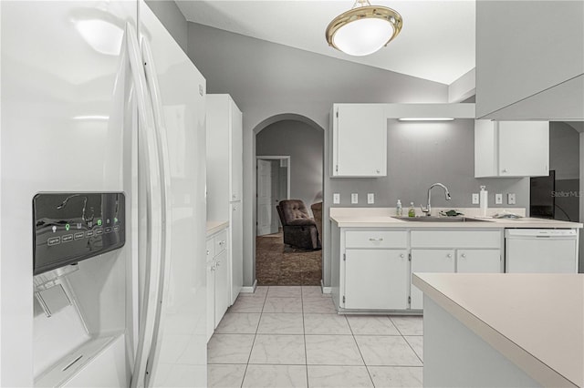 kitchen featuring vaulted ceiling, white dishwasher, white cabinets, and fridge with ice dispenser