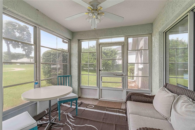 sunroom / solarium featuring ceiling fan