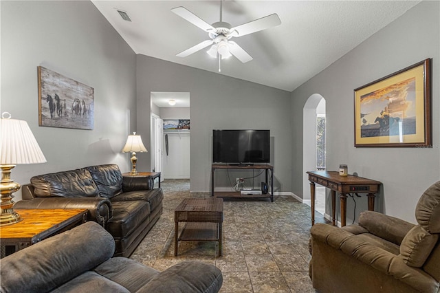 living room featuring tile patterned flooring, ceiling fan, and vaulted ceiling