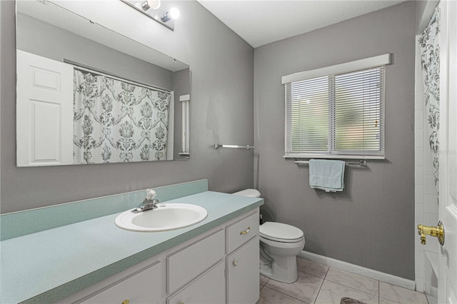 bathroom with vanity, tile patterned floors, and toilet