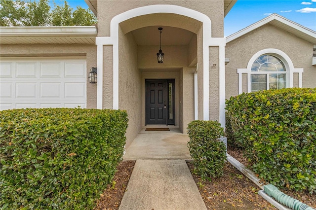 view of exterior entry featuring a garage