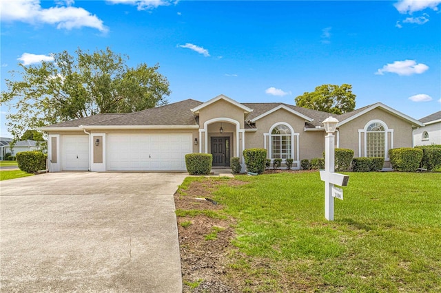 ranch-style house with a garage and a front lawn