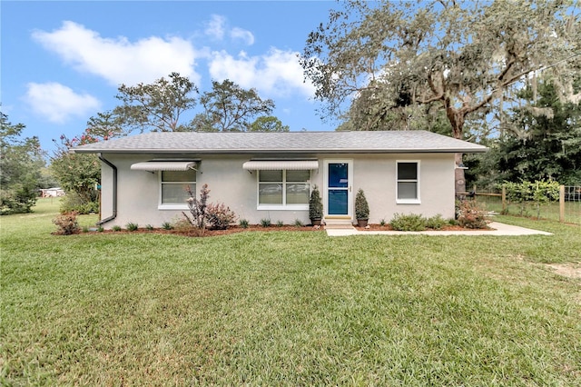 ranch-style house featuring a front yard