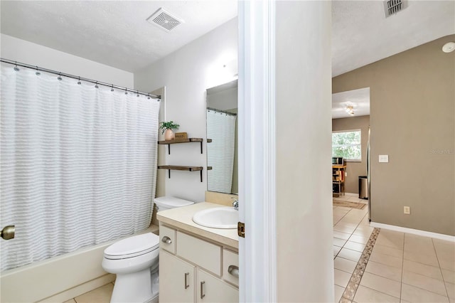 full bathroom featuring toilet, vanity, tile patterned flooring, a textured ceiling, and shower / tub combo with curtain