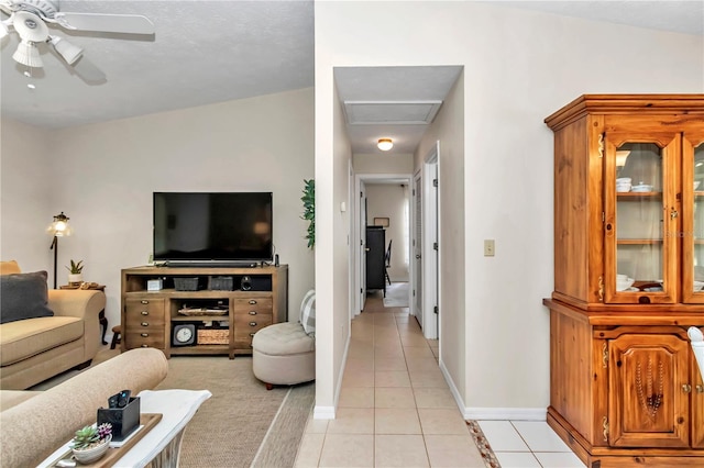 tiled living room featuring ceiling fan