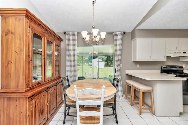 dining space featuring a textured ceiling, light tile patterned floors, and a chandelier