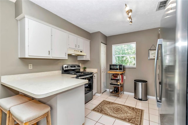 kitchen with white cabinets, stainless steel appliances, kitchen peninsula, a breakfast bar, and light tile patterned floors