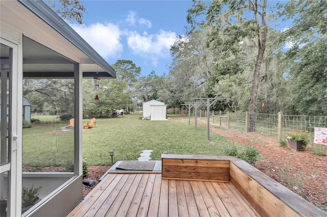 deck with a shed and a yard